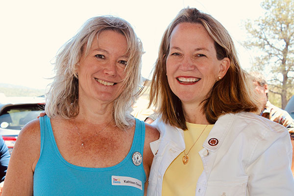Two smiling women at a party event